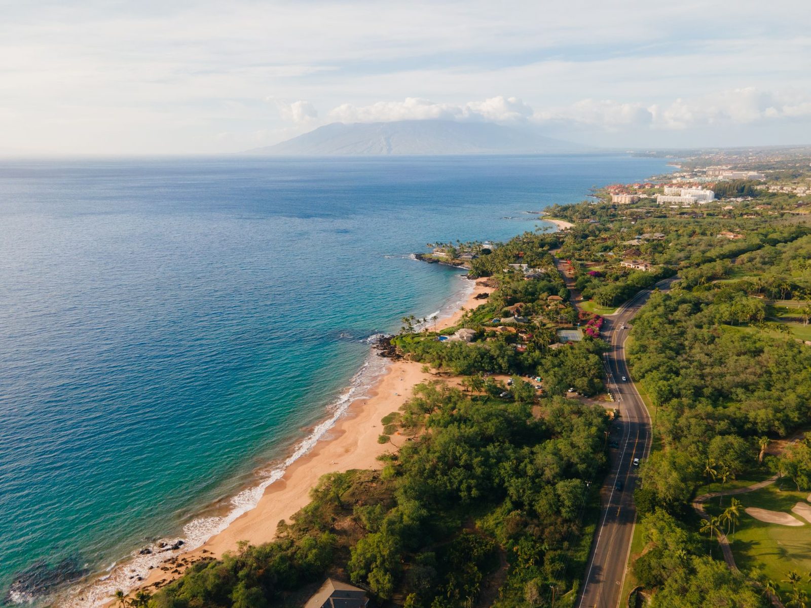 The South Maui shoreline at Kīhei from the air, with the West Maui mountains across the bay